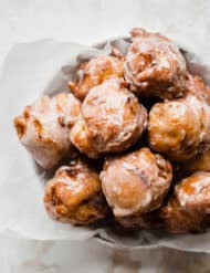 A pile of peach fritters on a plate.