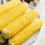 Sweet Boiled Corn on a white plate.