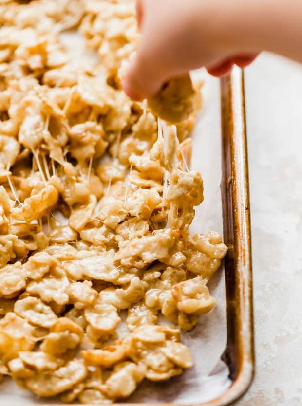 A hand pulling a small bunch of Special K Candy. 