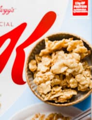 A bowl of Special K Cereal Candy sitting on top of a box of Special K Cereal.