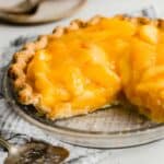 The best Fresh Peach Pie in a pie crust, with two slices removed from the pie.