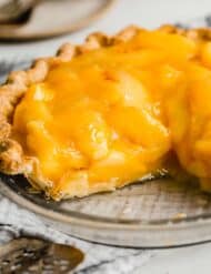 The best Fresh Peach Pie in a pie crust, with two slices removed from the pie.