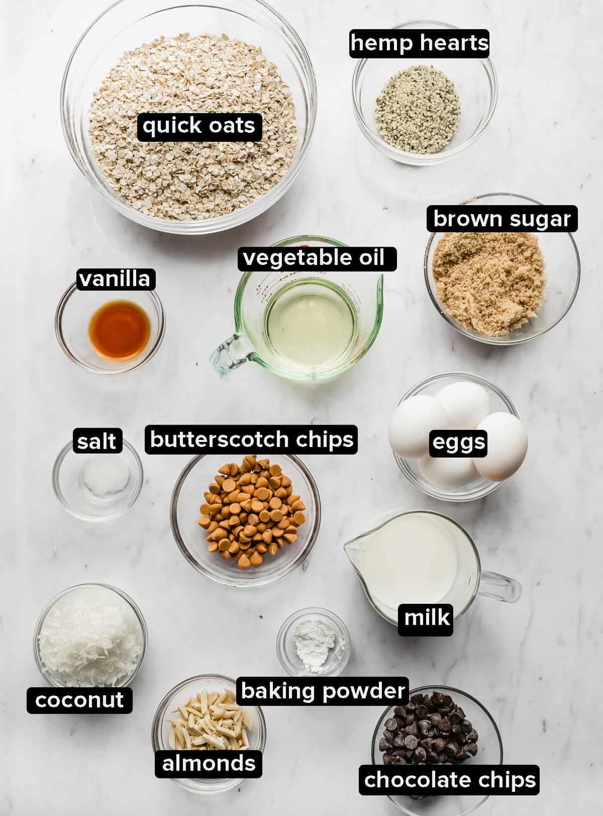 Baked oatmeal cake ingredients portioned into glass bowls on a white background.