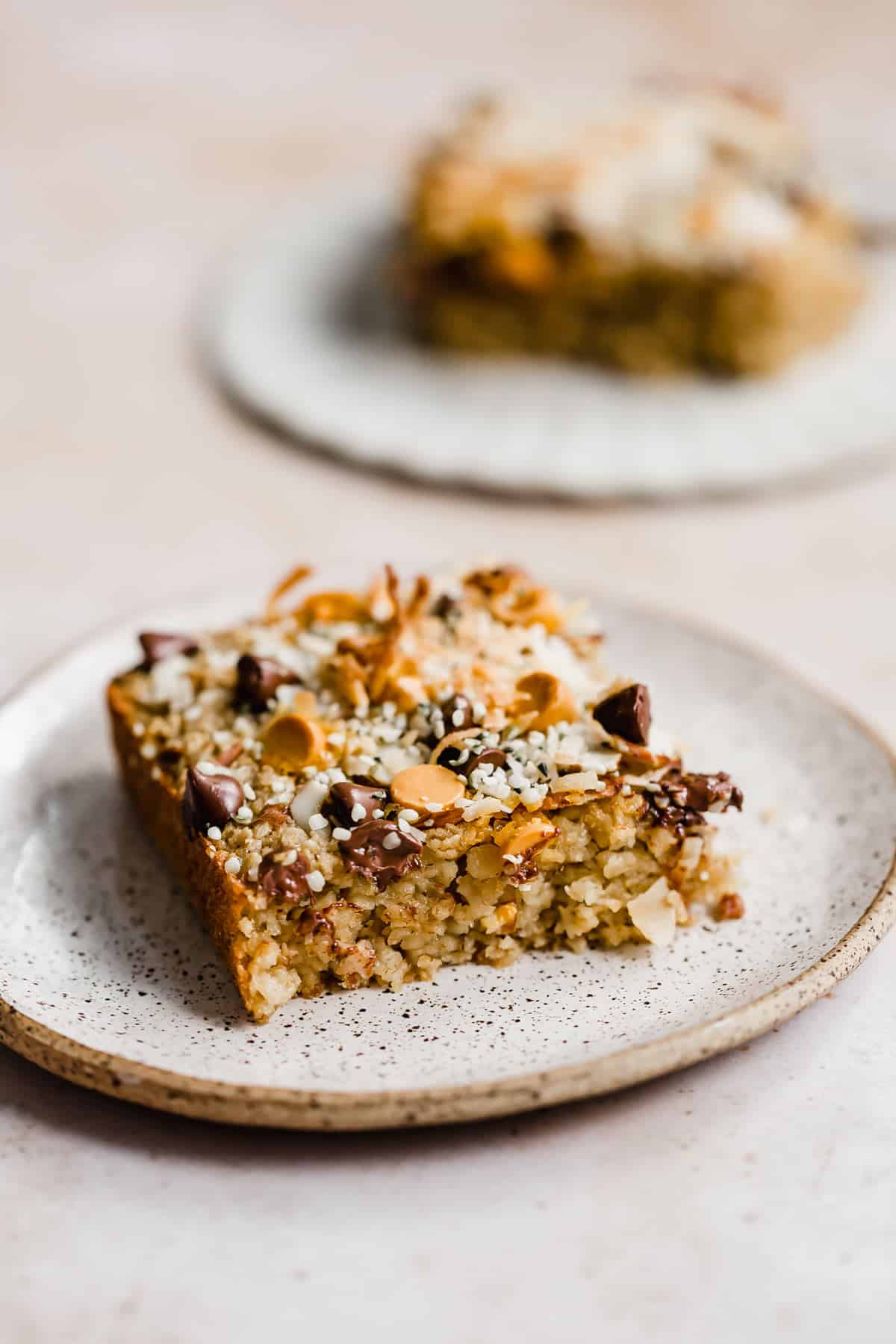 A square slice of Breakfast Baked Oatmeal Cake on a plate.