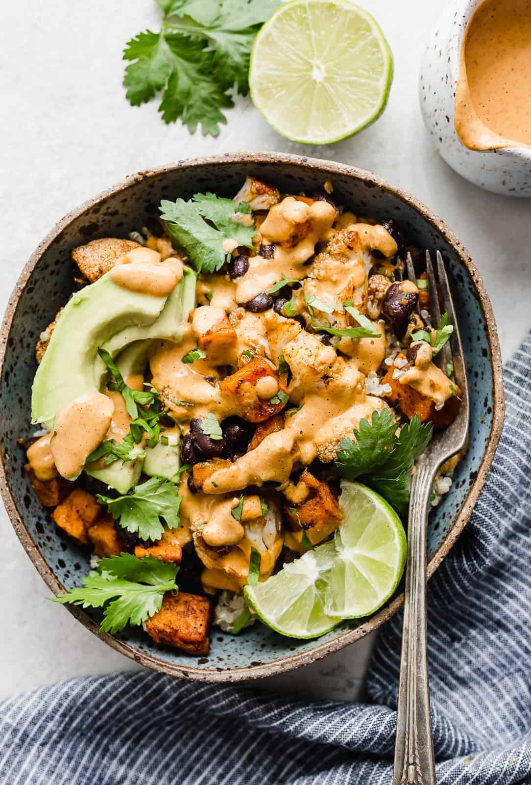 Overhead photo of a bowl with Roasted Sweet Potato, Cauliflower, and black beans in it.