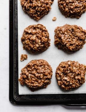 Small batch chocolate peanut butter no bake cookies on a white parchment paper.