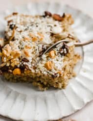 Baked Oatmeal Cake topped with coconut, butterscotch chips, chocolate chips, and hemp hearts.