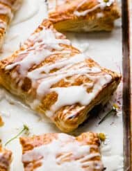 A Homemade Toaster Strudel made with puff pastry and topped with a white glaze.