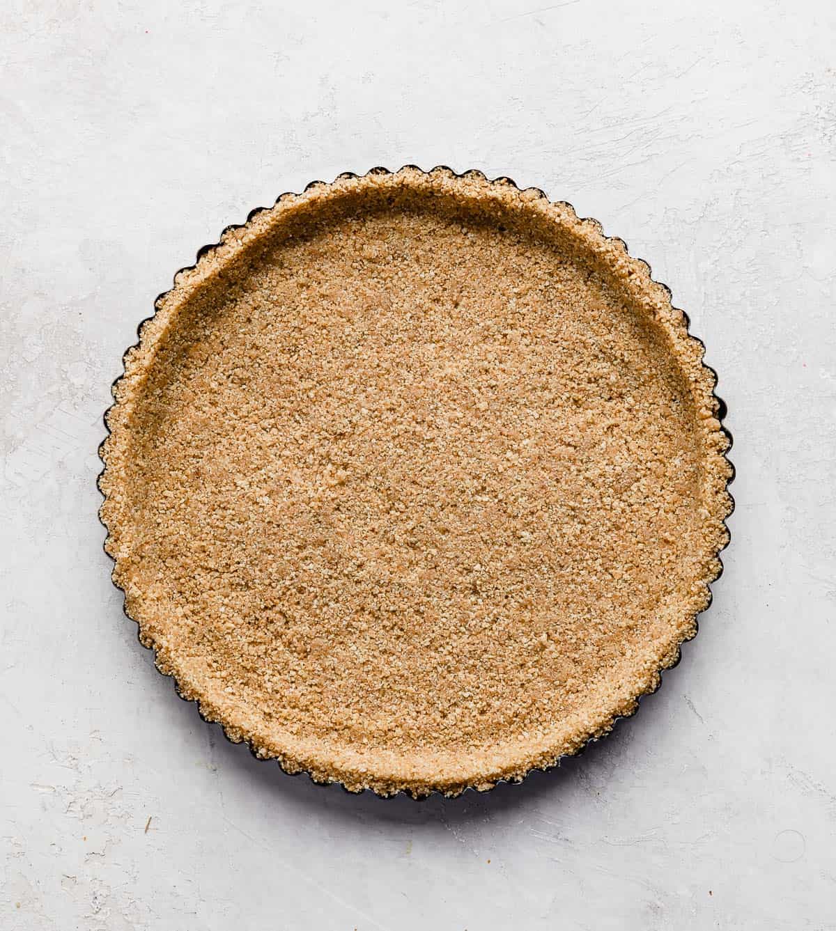 A graham cracker crust in a tart pan.
