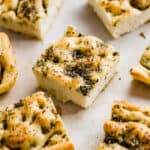 Herb topped fluffy Focaccia Bread cut into squares.