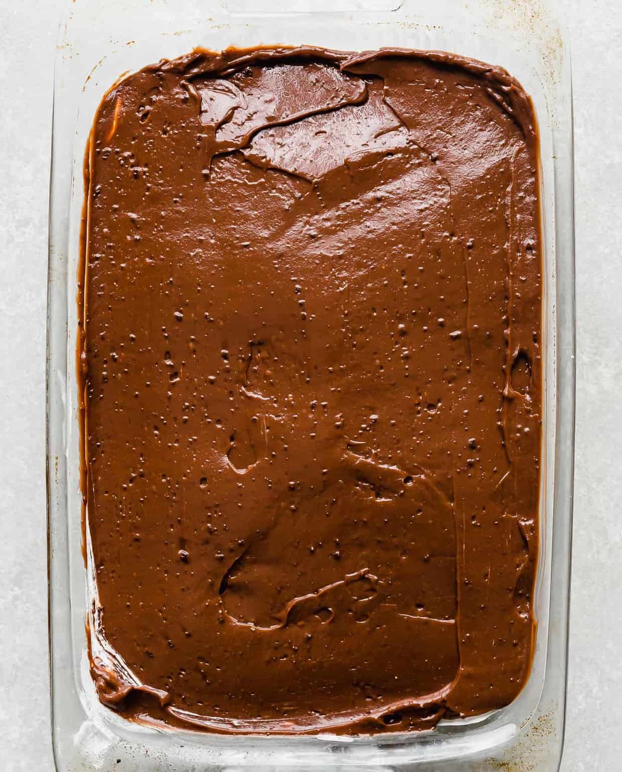 Chocolate pudding in an even layer in a casserole dish. 
