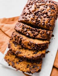 A sliced Pumpkin Chocolate Chip Bread on a white plate.