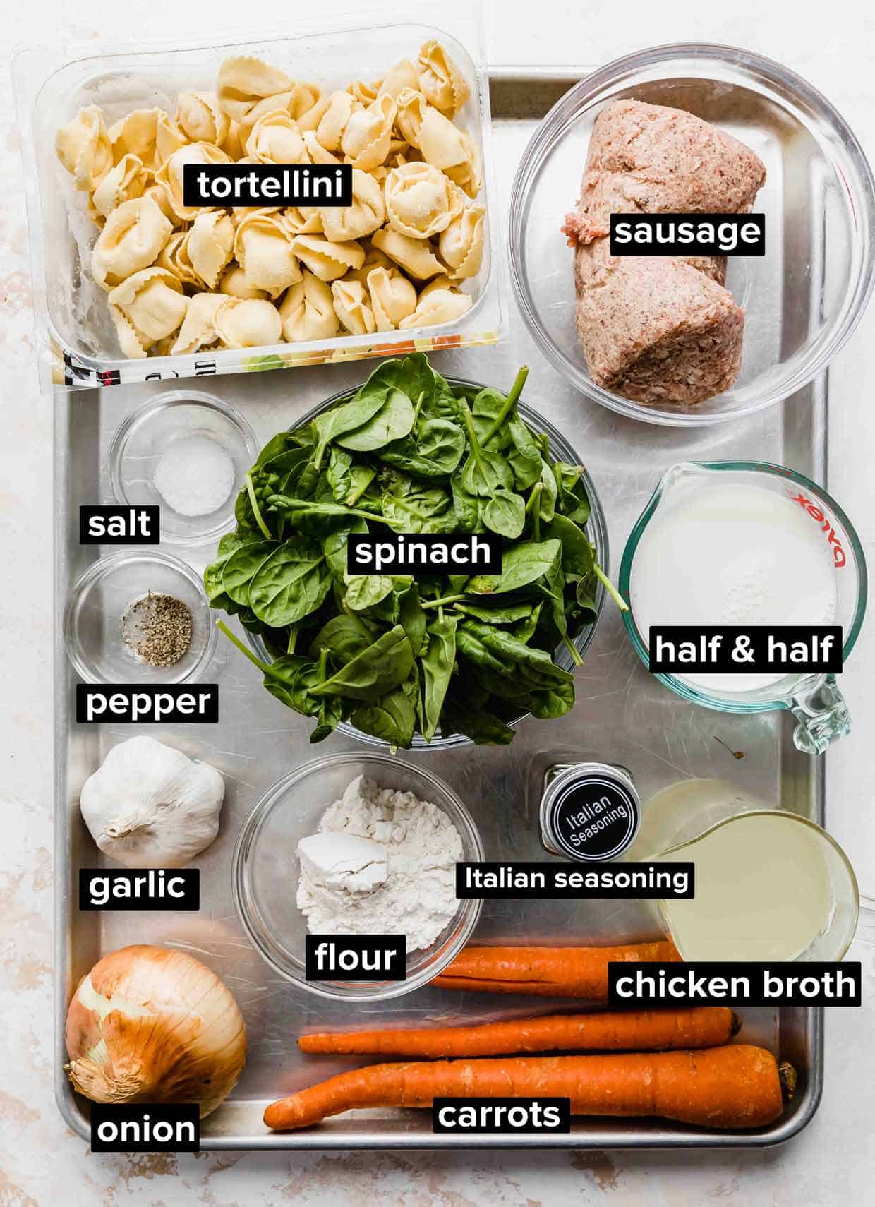 Sausage Tortellini Soup ingredients portioned out onto a baking sheet.