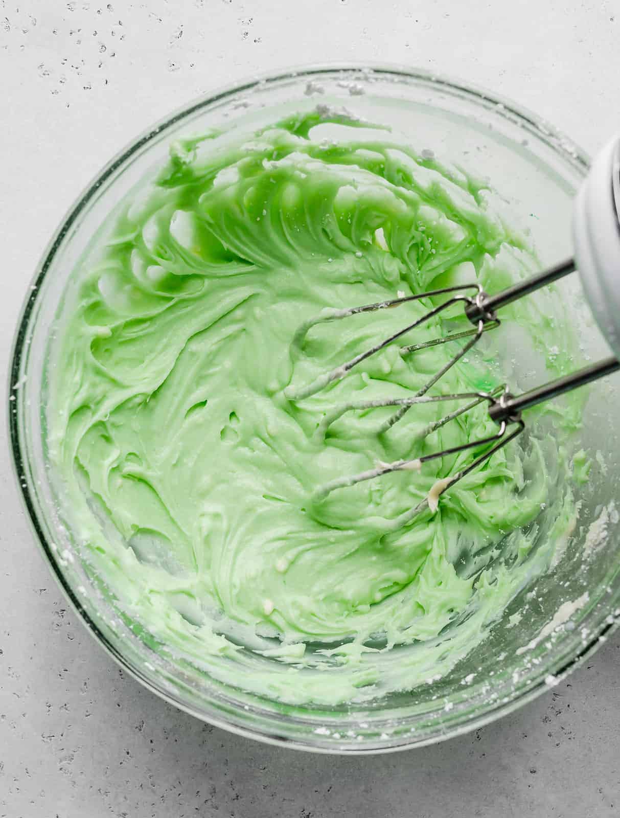 A bowl full of green mint frosting.