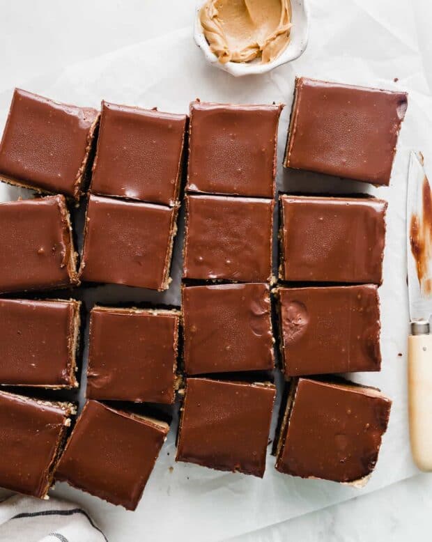 Buckeye Brownies topped with a chocolate ganache cut into squares.