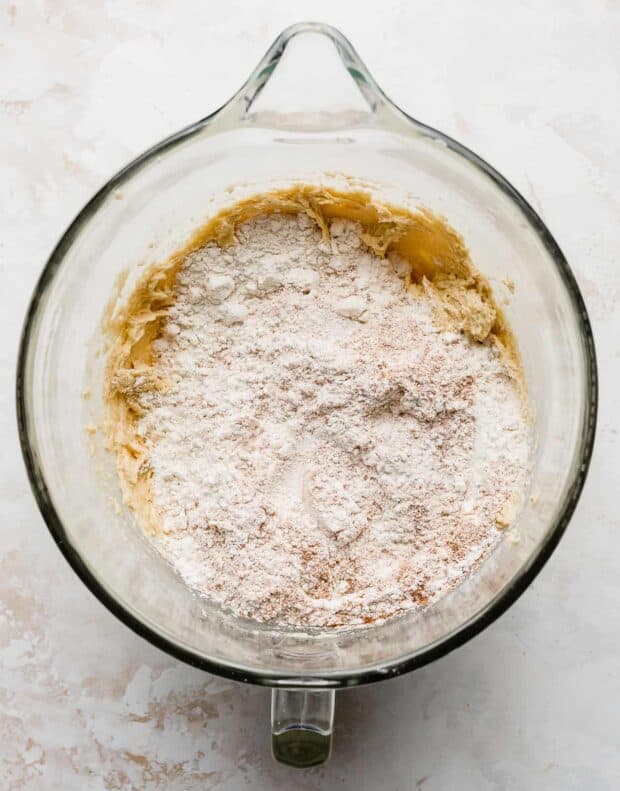 Flour on top of the cinnamon roll cookie batter's wet ingredients.