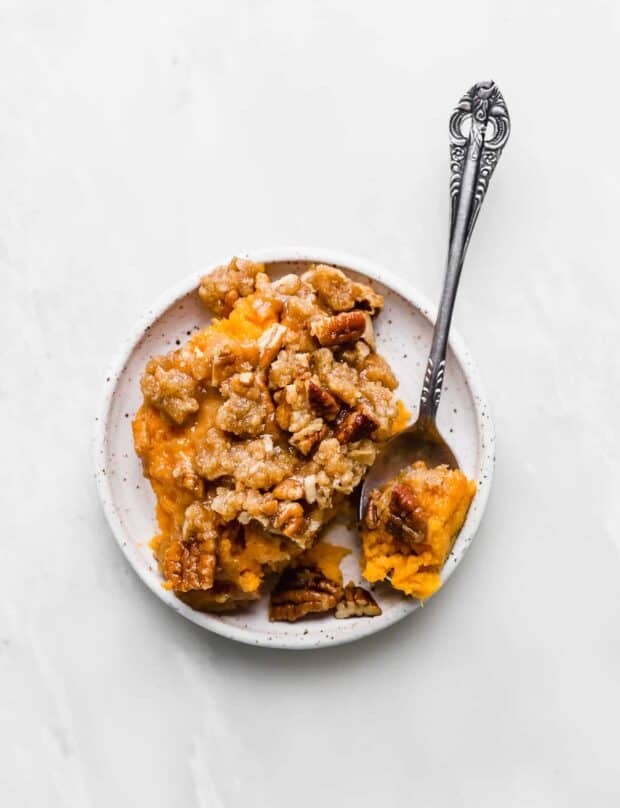 A white plate with Sweet Potato Casserole on it. 