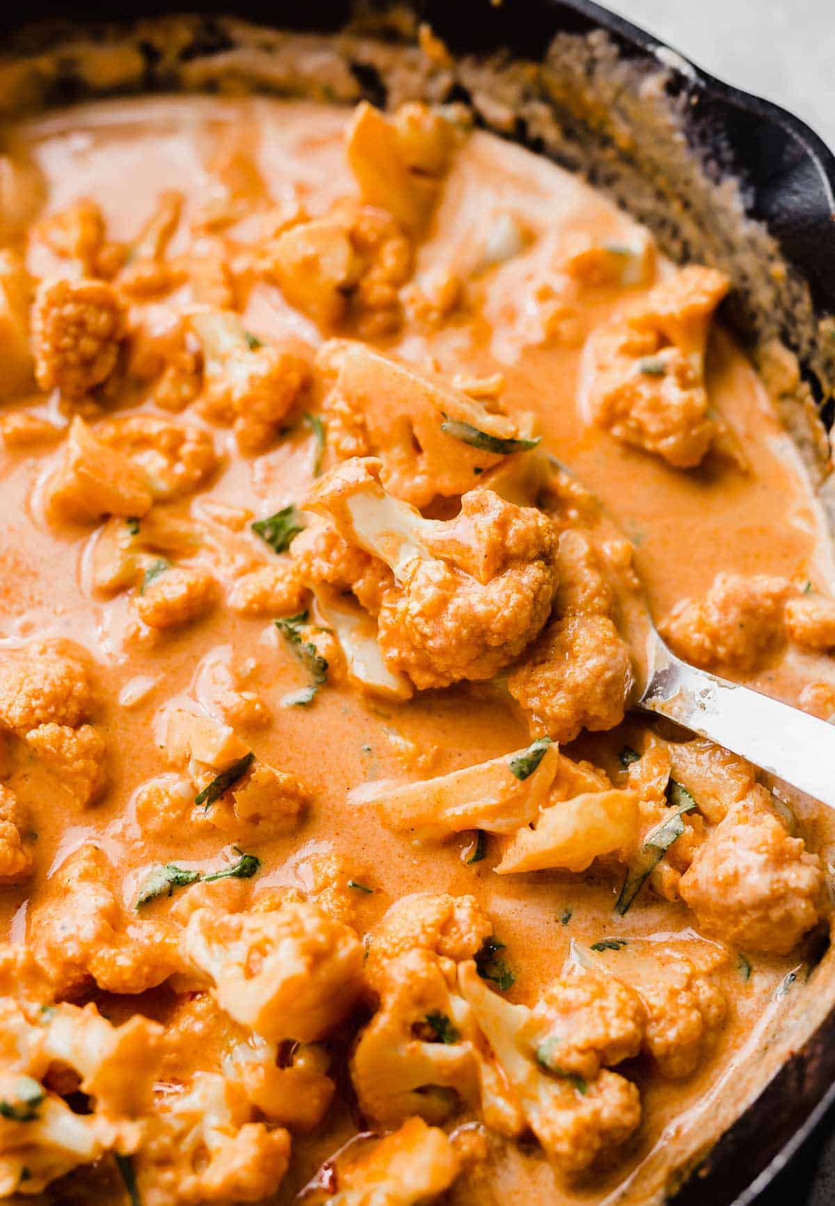 Close up photo of Indian Butter Cauliflower in a black skillet.