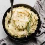 A black bowl full of Brown Butter Rosemary Mashed Potatoes.