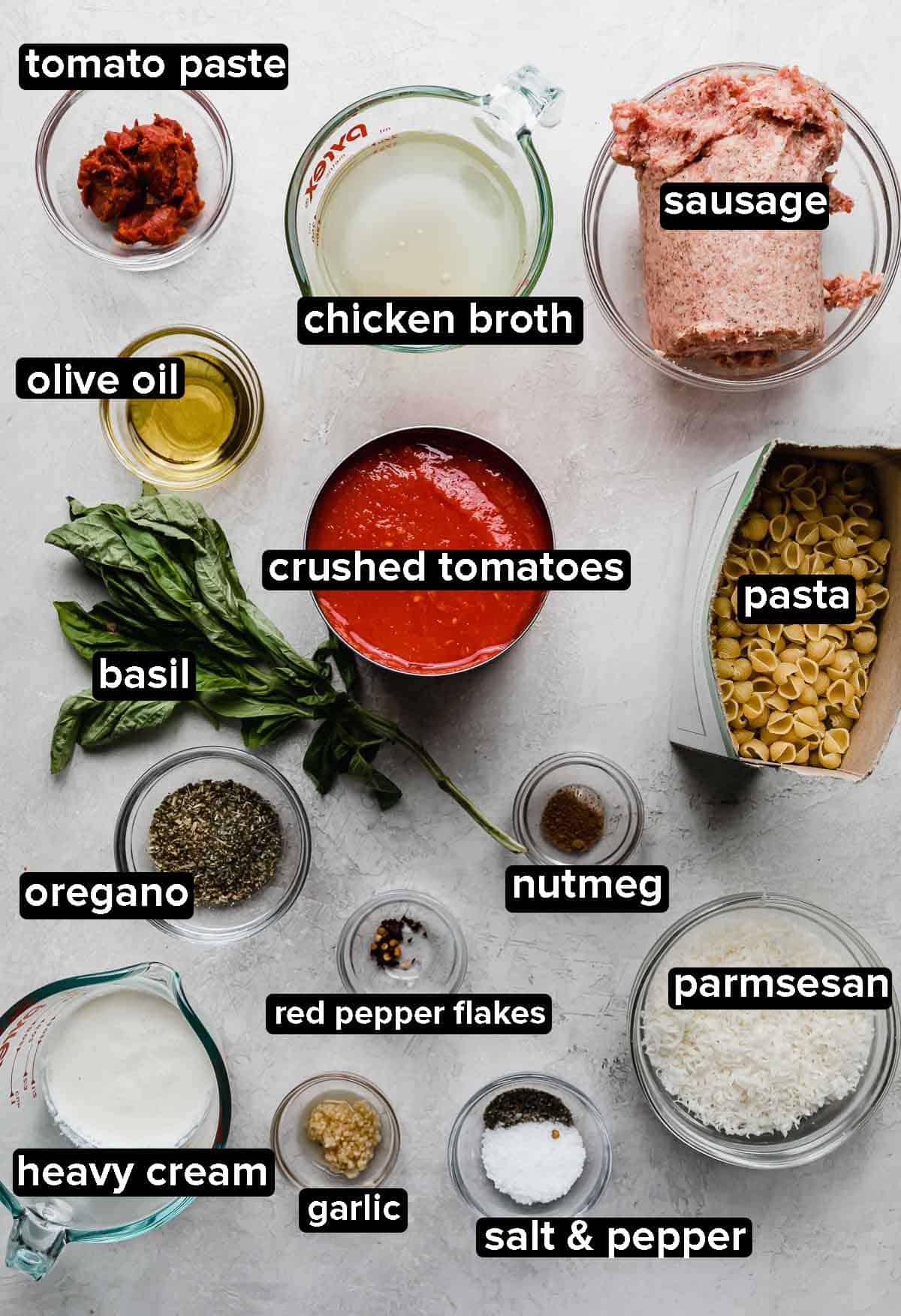 The Best Bolognese Sauce ingredients portioned into glass bowls on a light gray background.