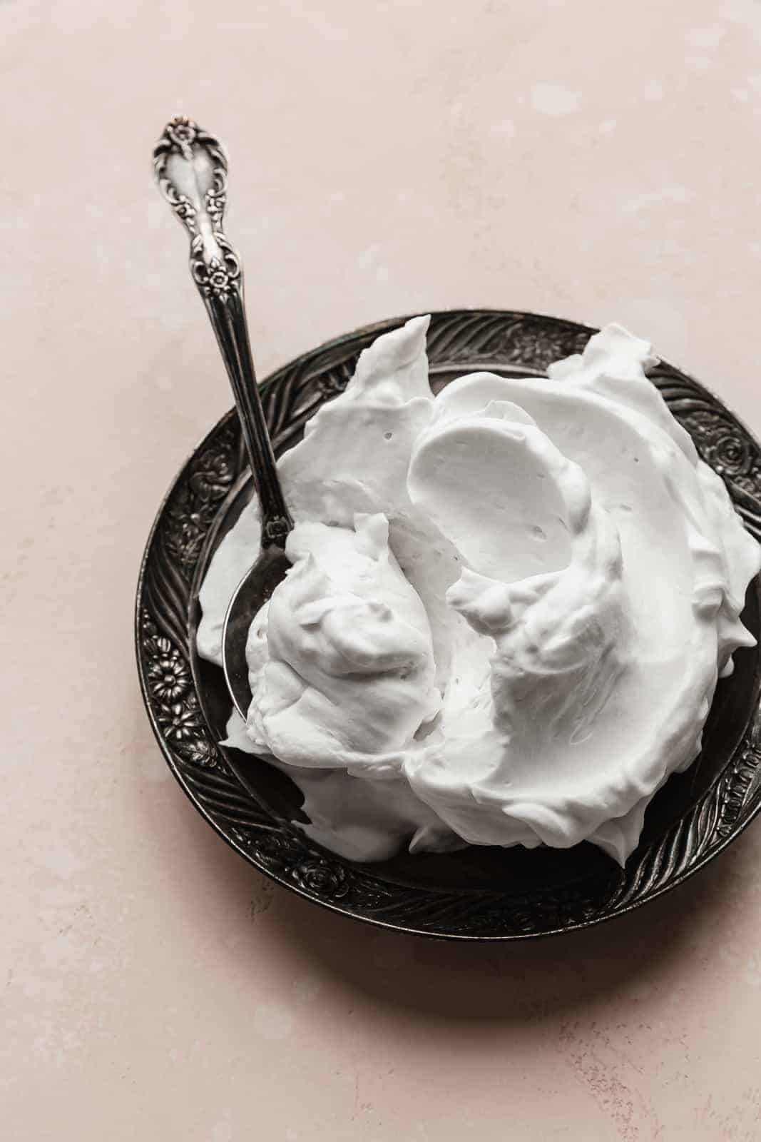 A spoon scooping up Coconut Whipped Cream.