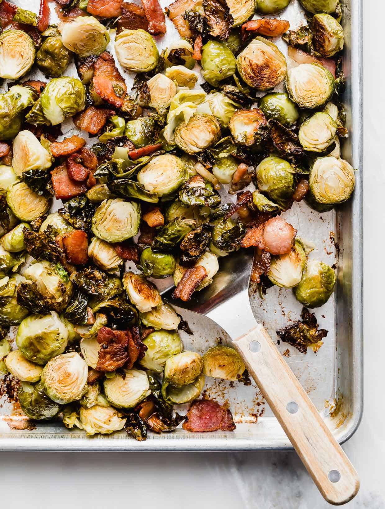 A baking sheet with Roasted Brussels Sprouts with Bacon on it.