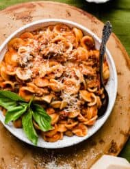 A white pasta bowl filled with the Best Bolognese Sauce and noodles.