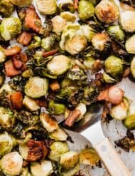 A sheet pan with Roasted Brussels Sprouts with Bacon on it.