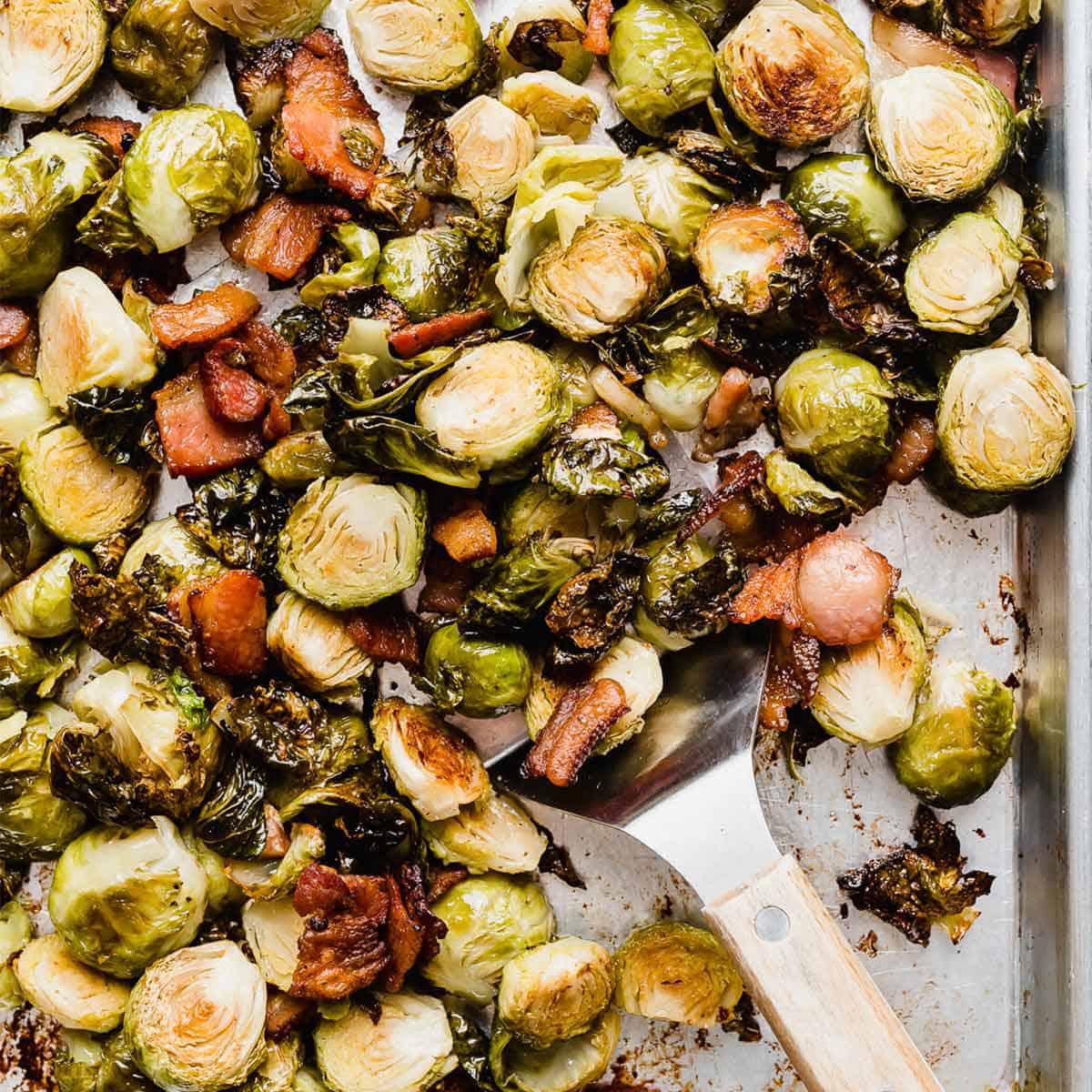 A sheet pan with Roasted Brussels Sprouts with Bacon on it.