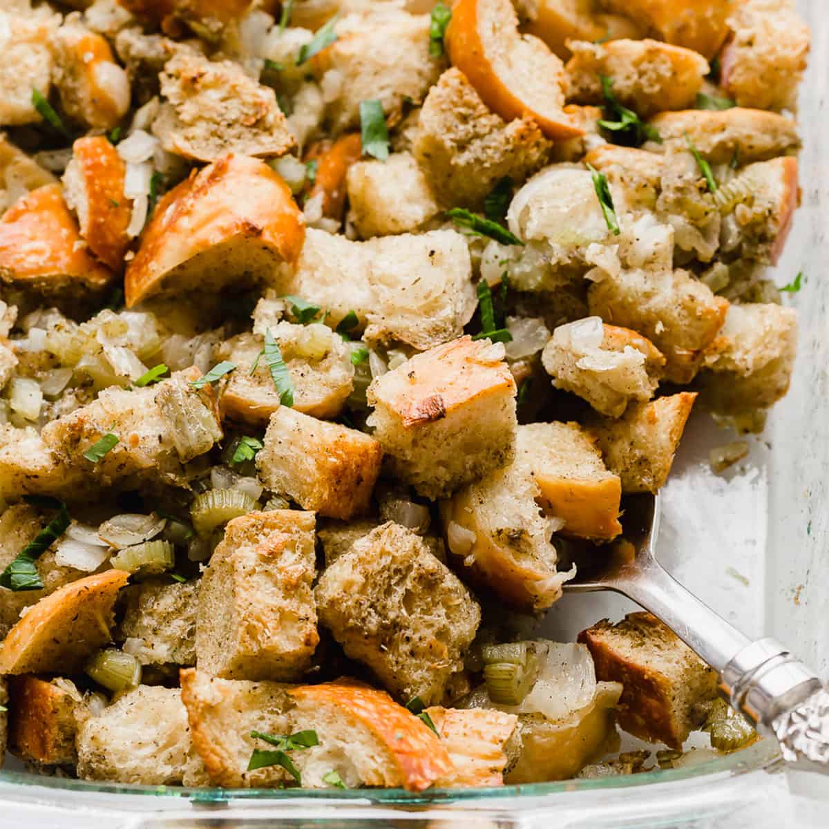 A close up photo of golden baked Thanksgiving Stuffing Recipe. in a baking dish.