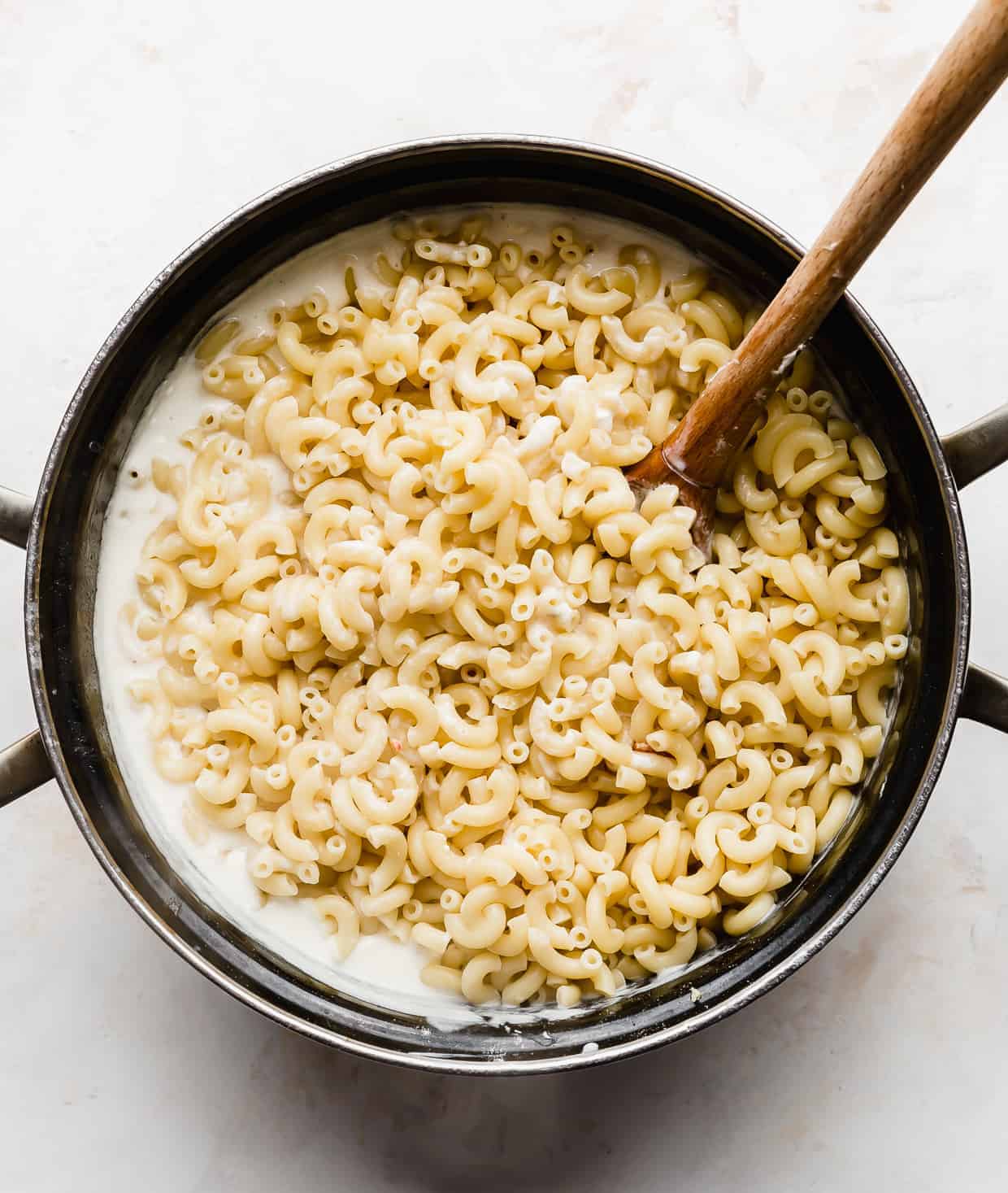 Cooked macaroni noodles in a large pot.