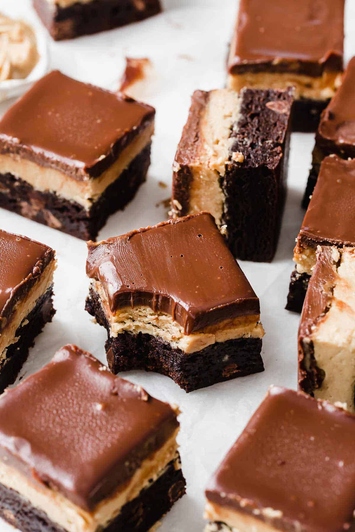 A Buckeye Brownie on a white background with a bite taken out of it.