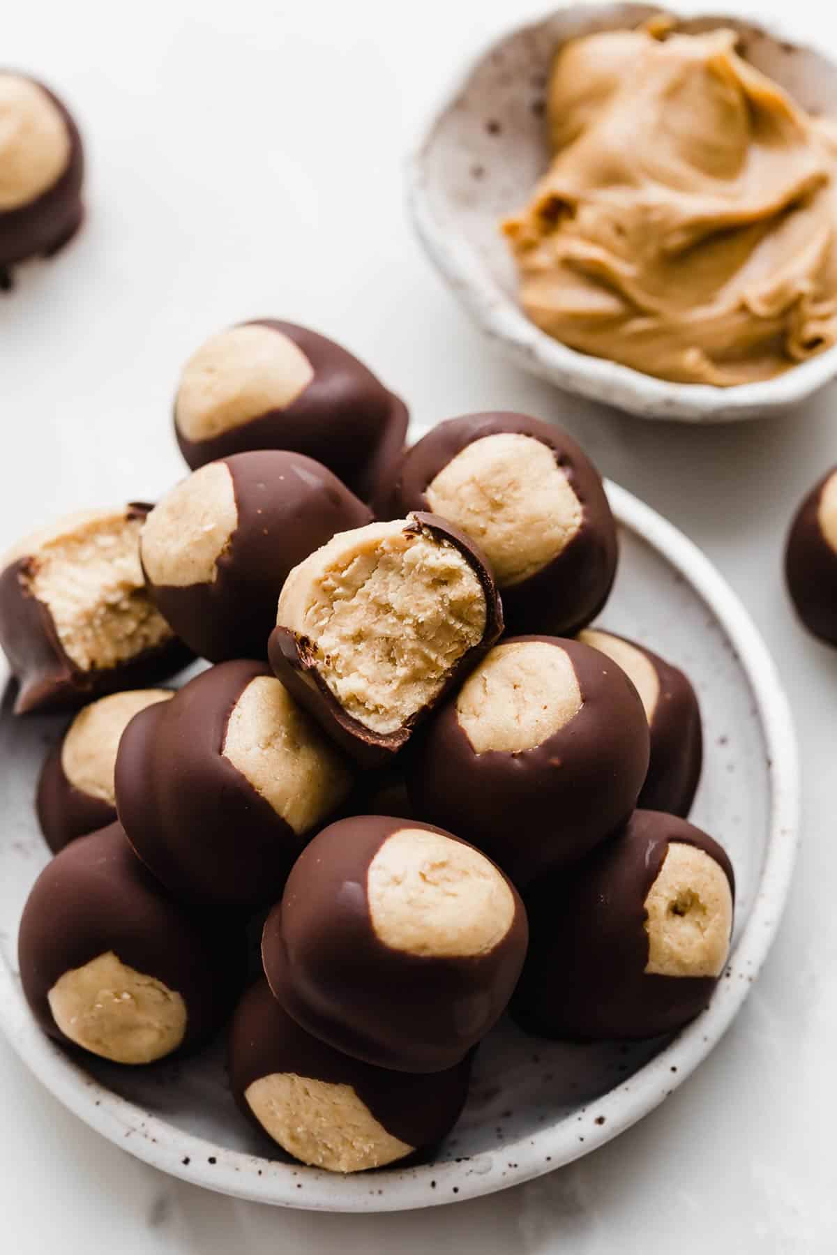 A white plate topped with homemade Buckeyes.