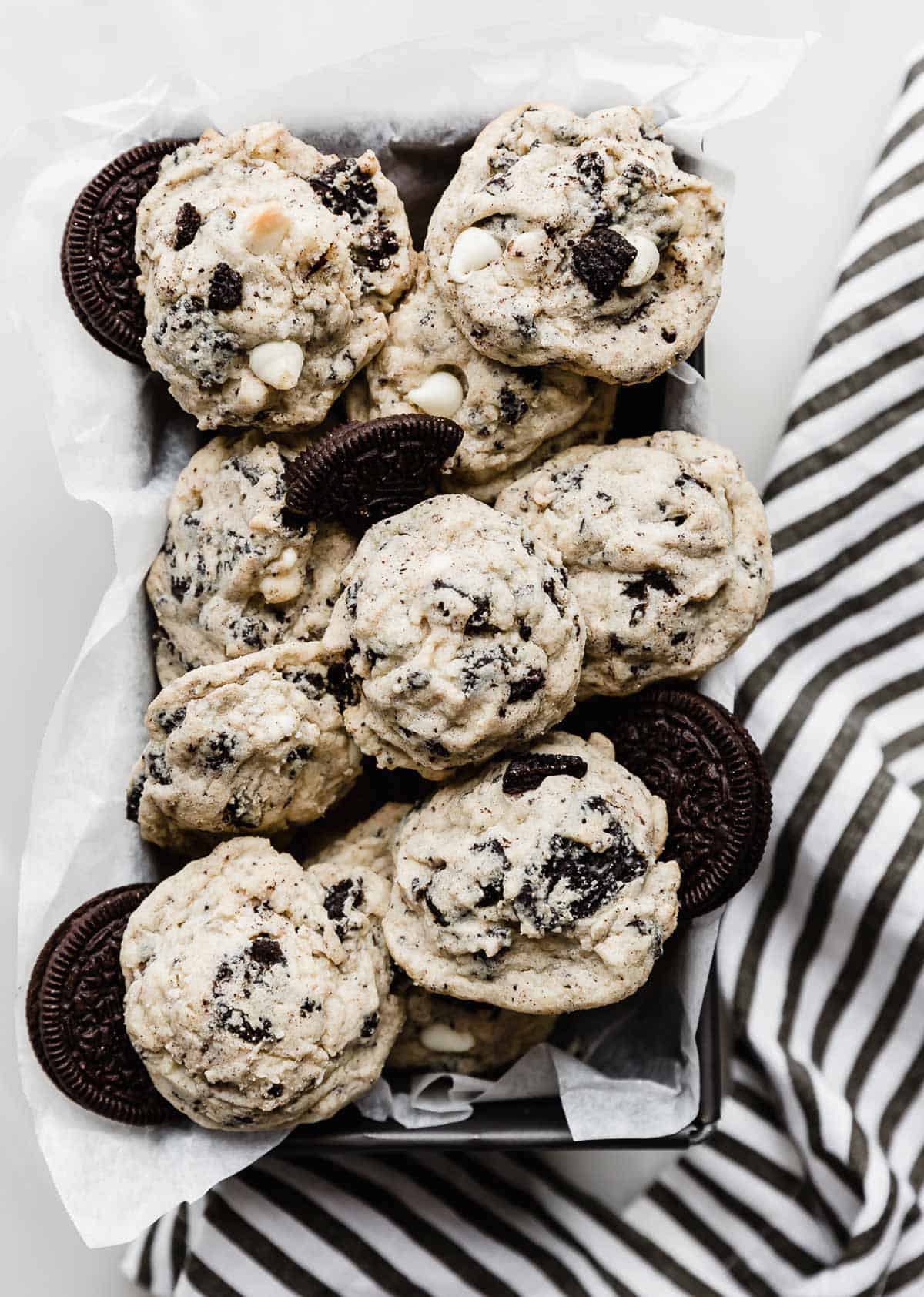 Cookies and Cream Cookies stacked on top of each other on a rectangular bread pan.