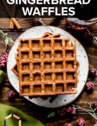 Gingerbread Waffles on a white plate with the words, "Gingerbread Waffles" written in white text over the photo.
