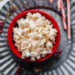 Christmas Candy Cane Popcorn in a red bowl.