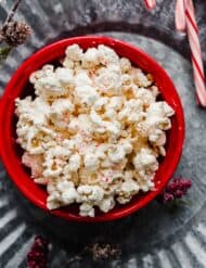 Christmas Candy Cane Popcorn in a red bowl.