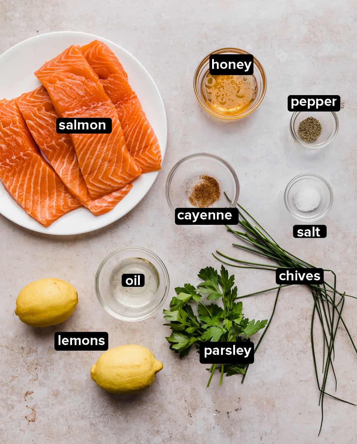 Lemon Honey Glazed Salmon ingredients on a textured tan background.