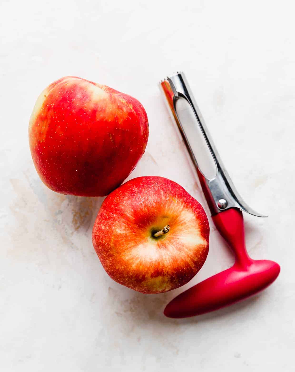 Two red apples against a white background.