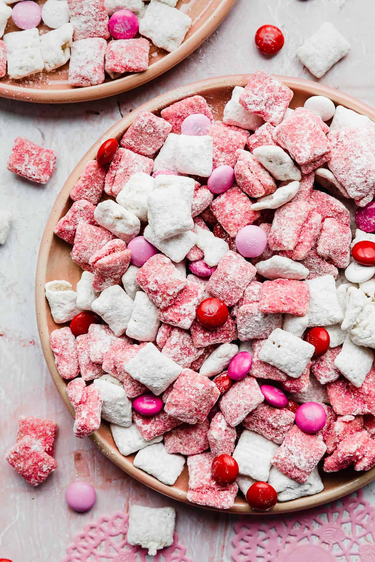 A close up photo of bright pink and white covered Valentine's Day Muddy Buddies.
