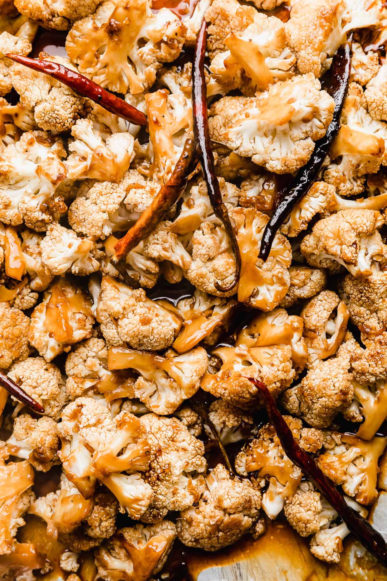 A close up photo of Kung Pao Cauliflower on a baking sheet.