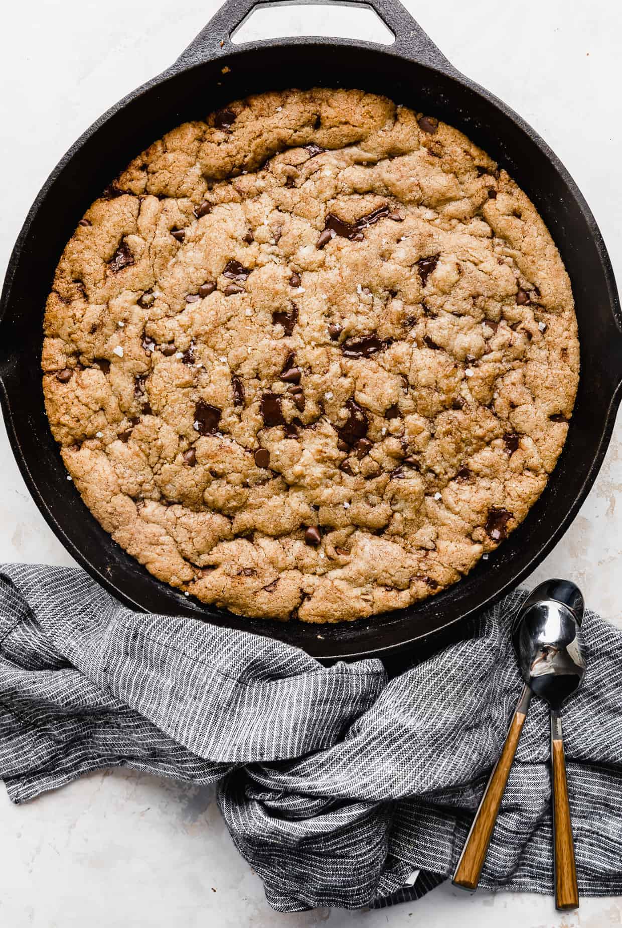 A pizookie in a skillet on a white background.