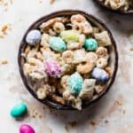 Bunny Bait with peanut butter M&M's, nuts, Cheerios, and coconut, in a black bowl.
