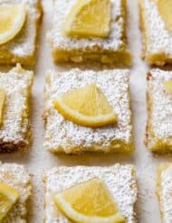 Lemon Bar squares topped with a small slice of lemon.