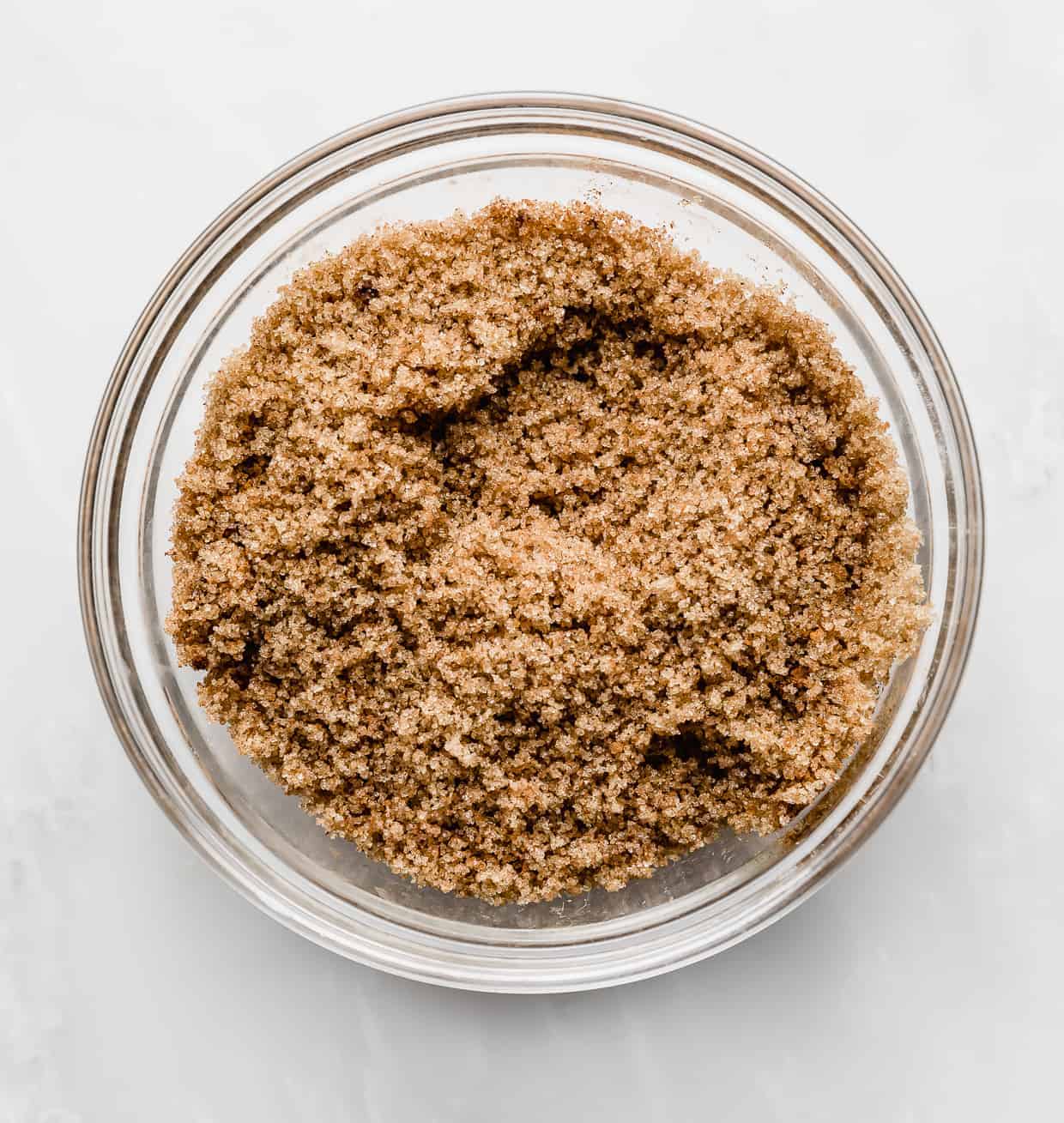 Brown sugar and cinnamon mixture in a glass bowl.