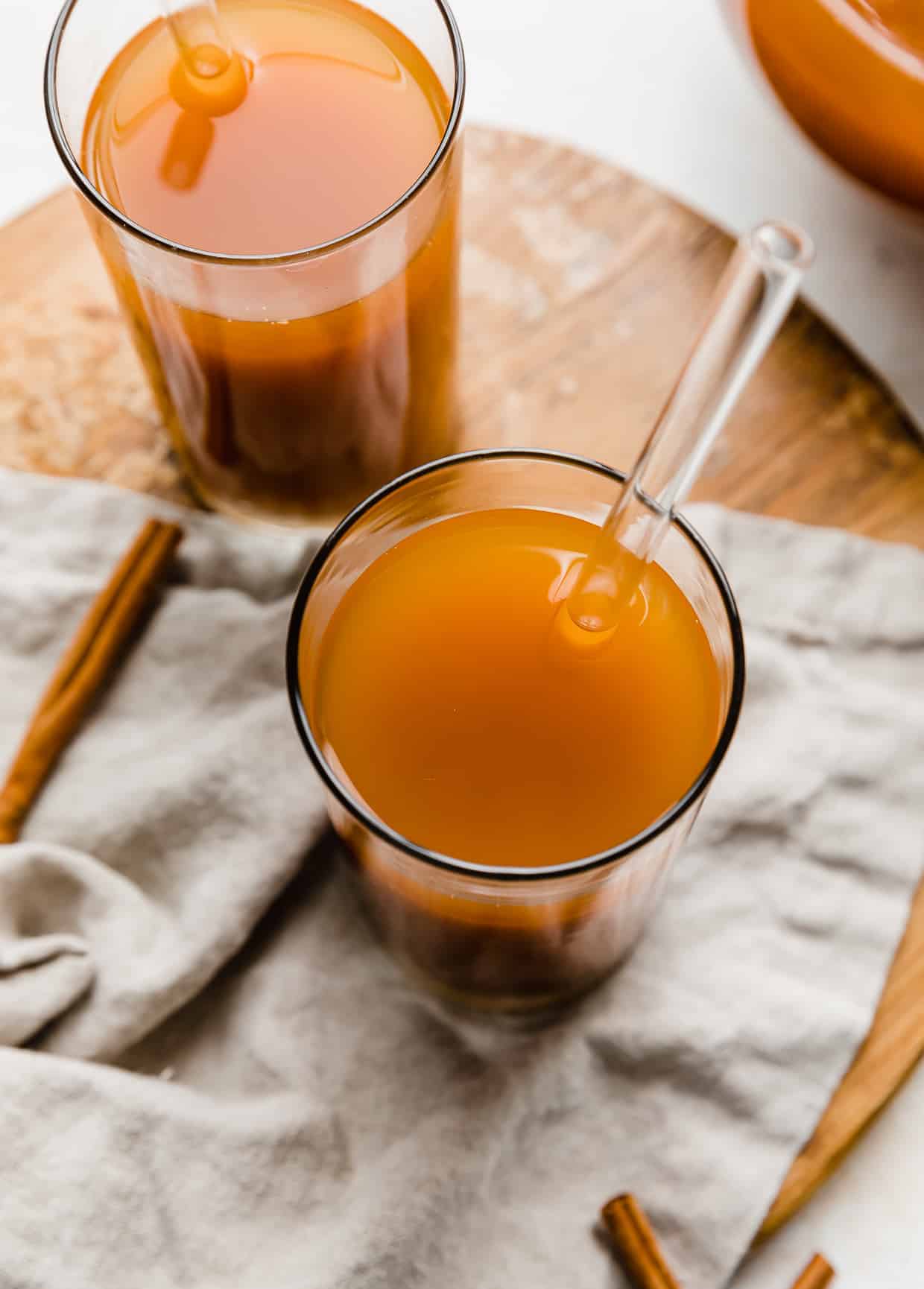 Overhead photo of Pumpkin Juice in a glass cup with a glass straw in the drink.