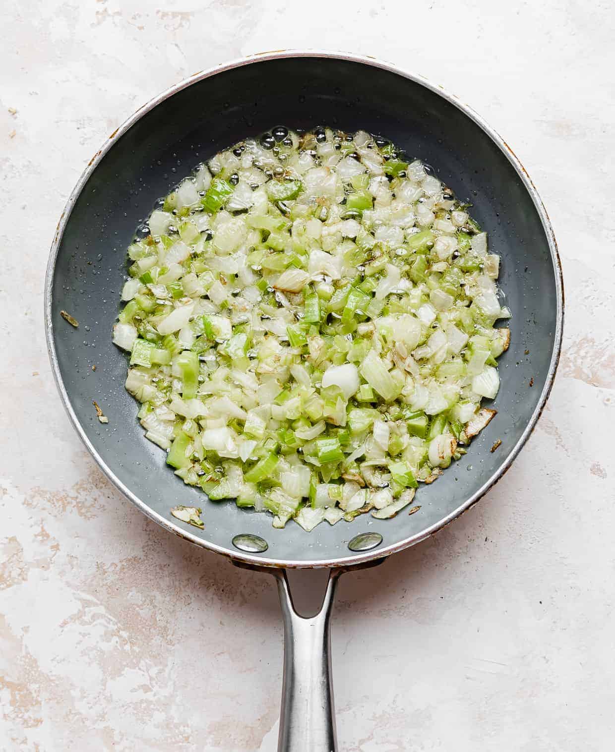Cooked diced onion and celery in a small skillet.