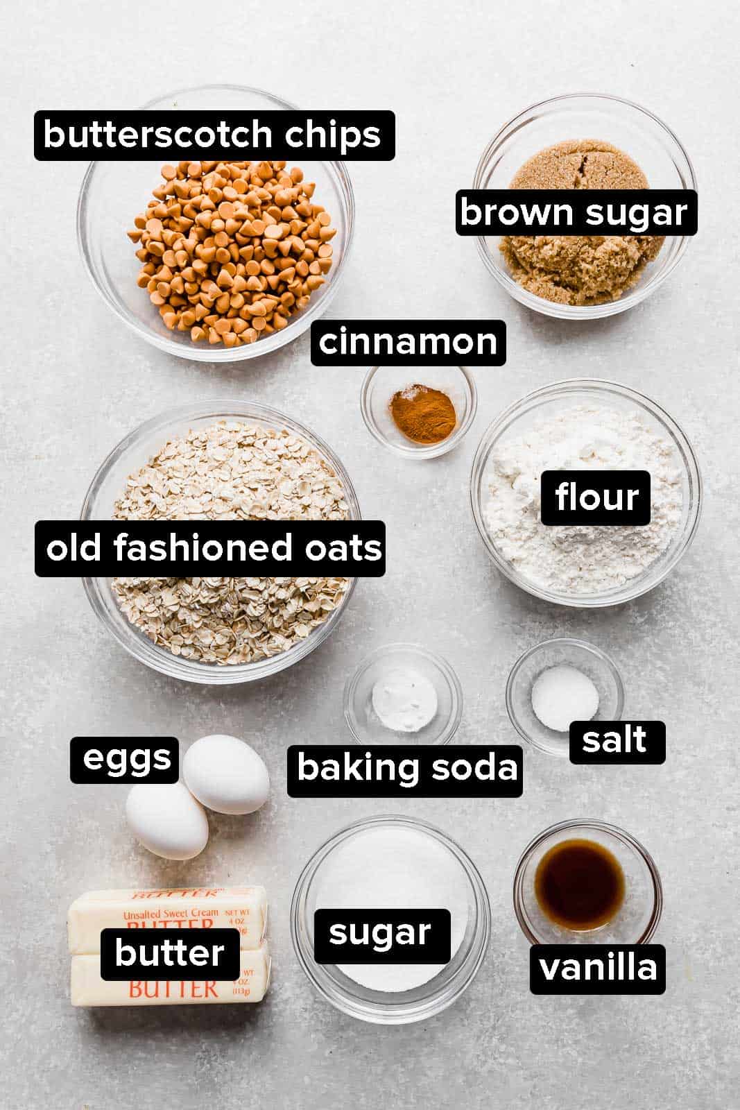 Ingredients used to make oatmeal scotchies on a gray background.