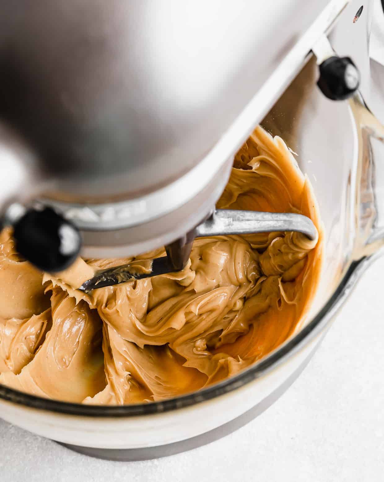 Creamy Peanut Butter Frosting being mixed in a stand mixer.