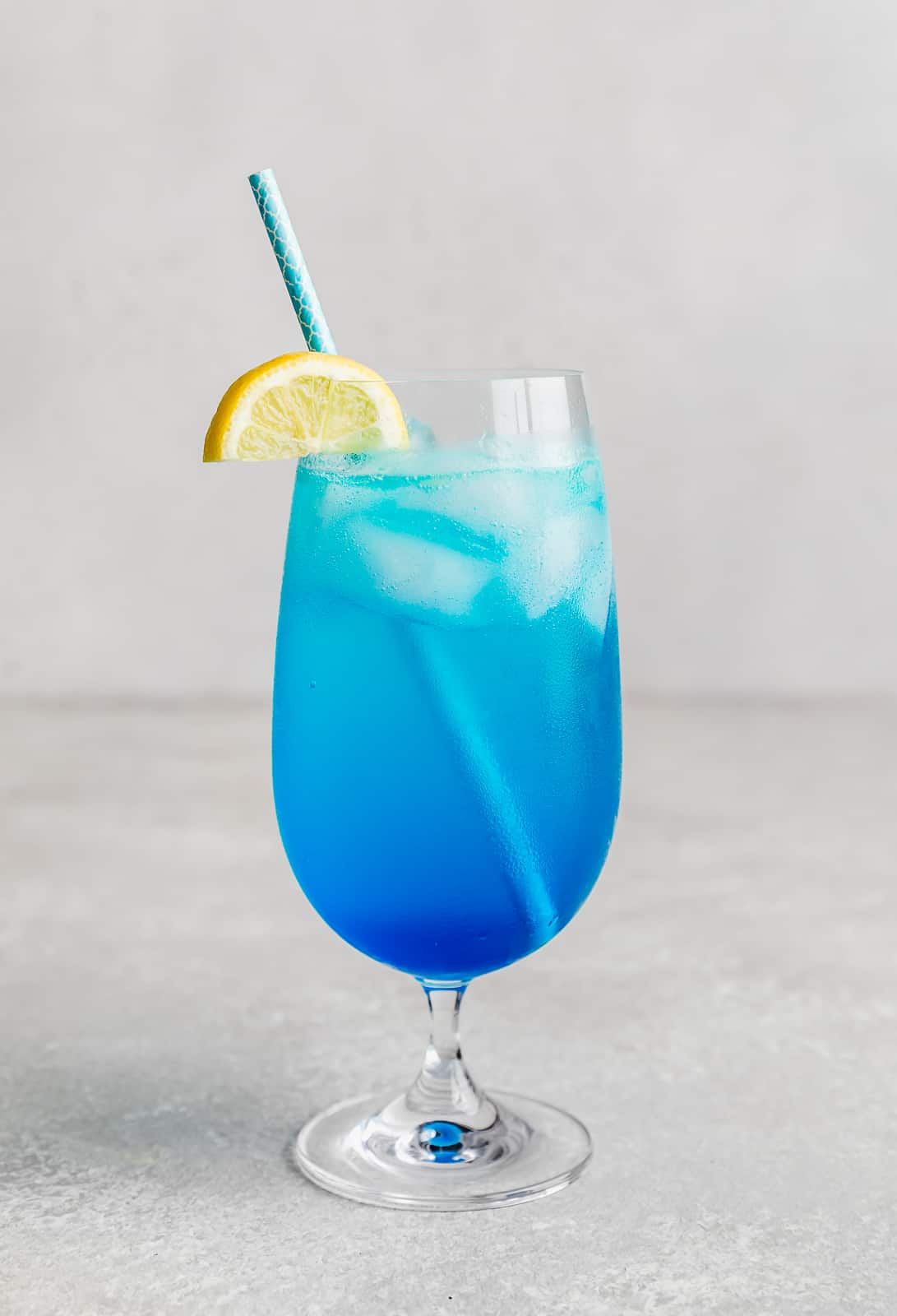 A Blue Lagoon Mocktail against a white background.